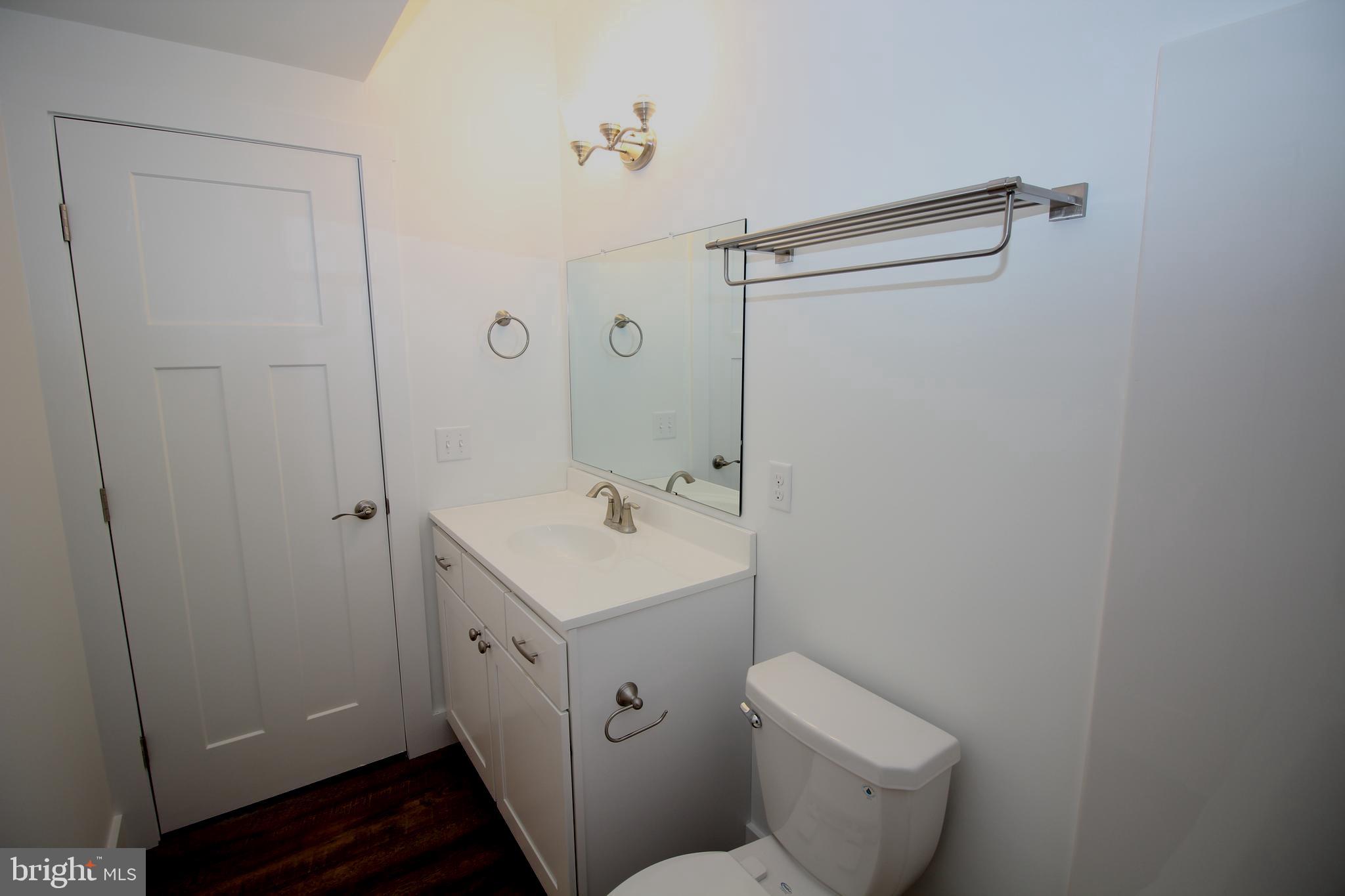 306 Main Street Dover, DE 19901 - Photo 12 of 33 a bathroom with a toilet sink and mirror
