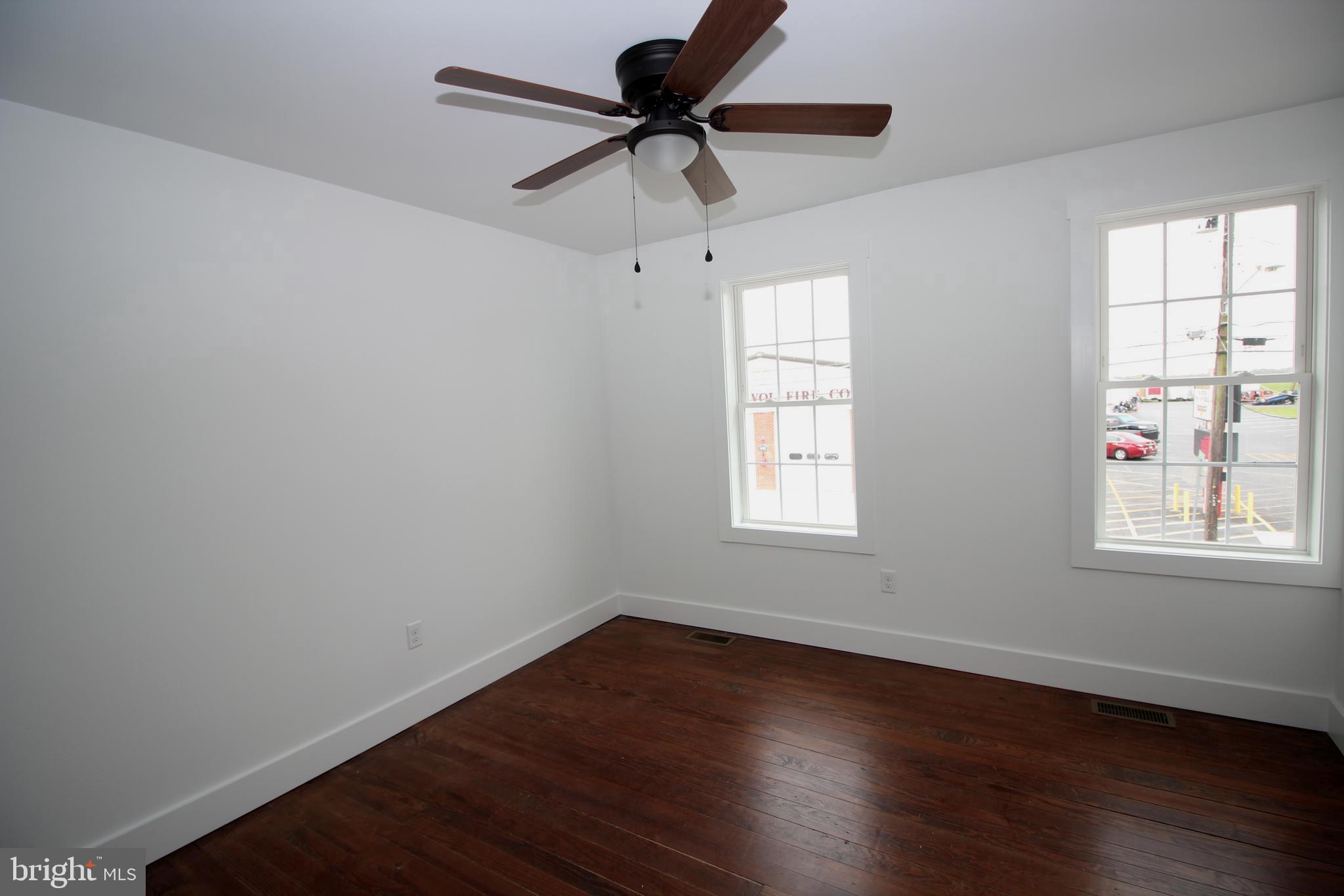 306 Main Street Dover, DE 19901 - Photo 20 of 33 a room with window and wooden floor