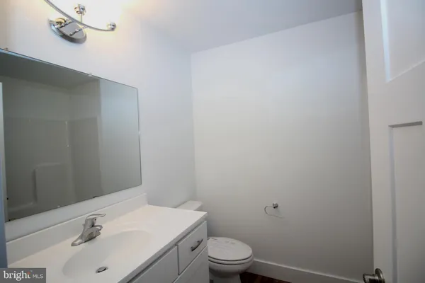 a bathroom with a sink a toilet and vanity