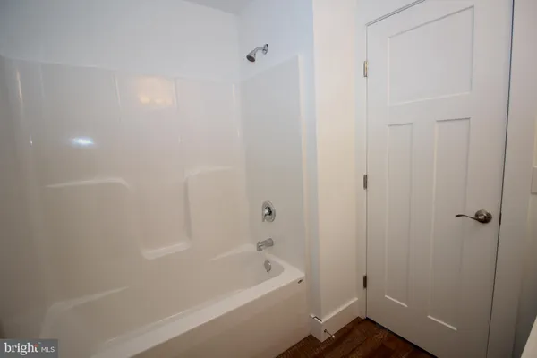 a bathroom with a tub and shower