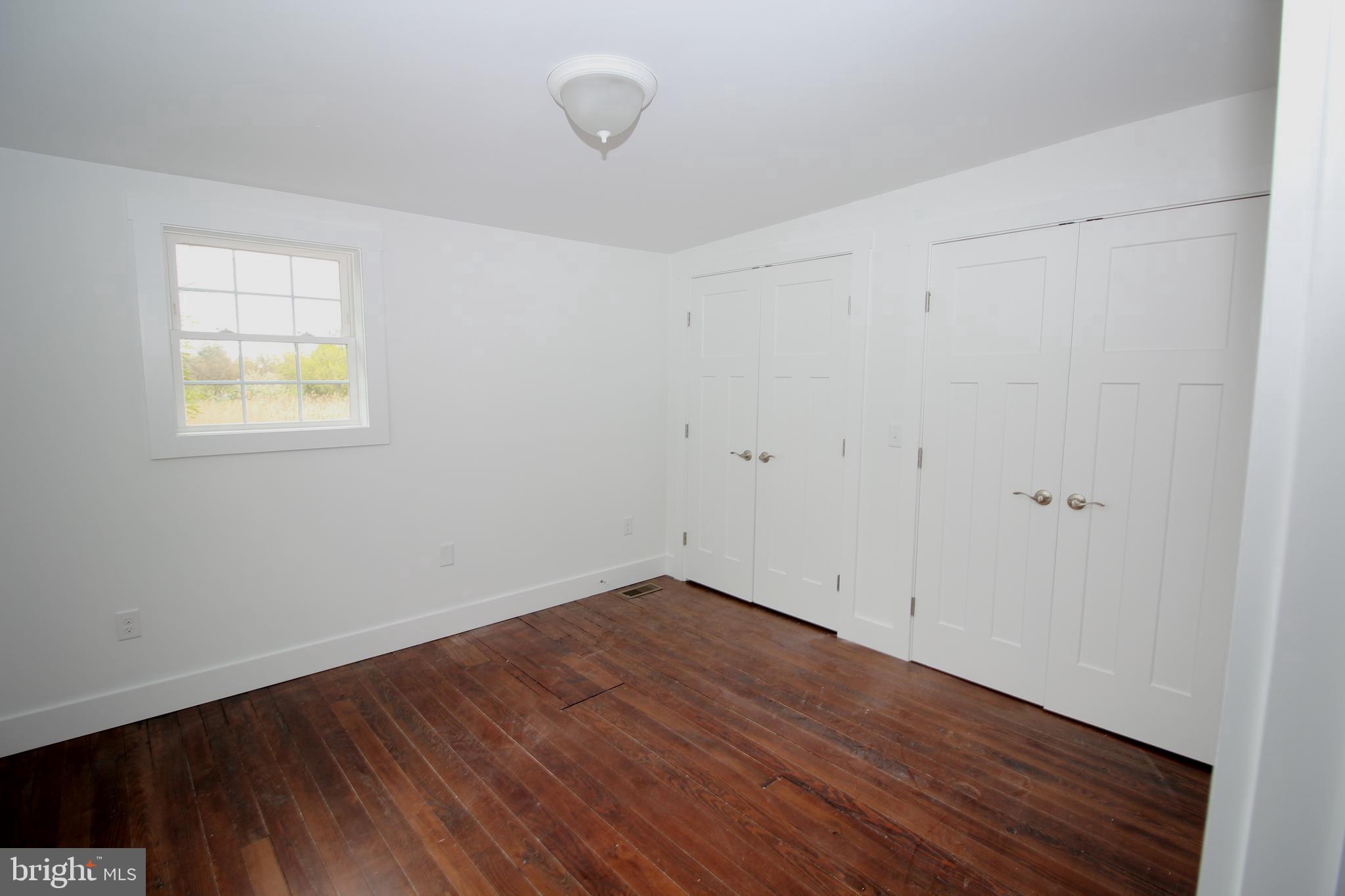 306 Main Street Dover, DE 19901 - Photo 26 of 33 a view of an empty room with wooden floor and a window