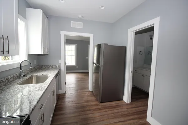 a kitchen with a refrigerator and a sink