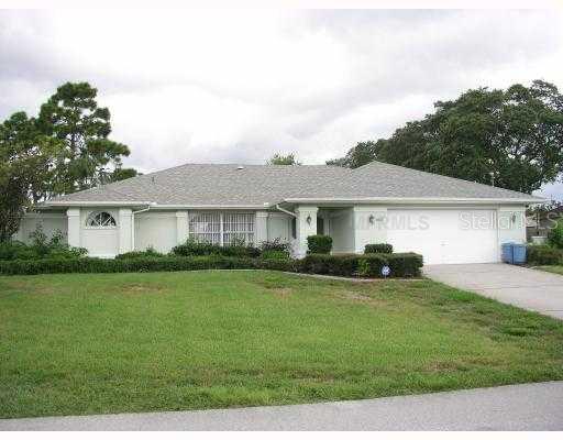 11145 Timbercrest Road Spring Hill, FL 34608 - Photo 1 of 1 a front view of a house with a garden and yard