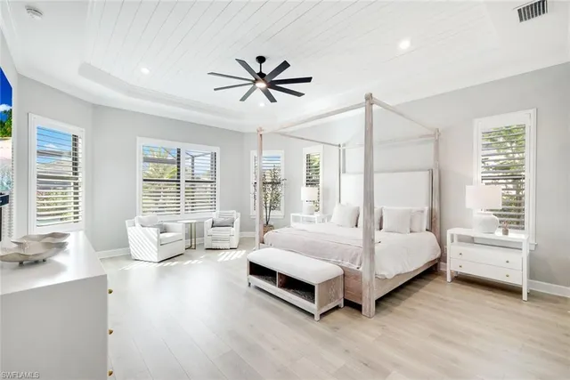 a spacious bedroom with a bed and large window