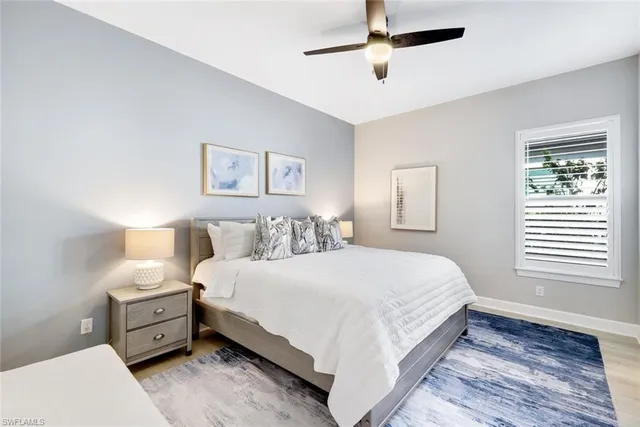 a large bedroom with a bed and a window