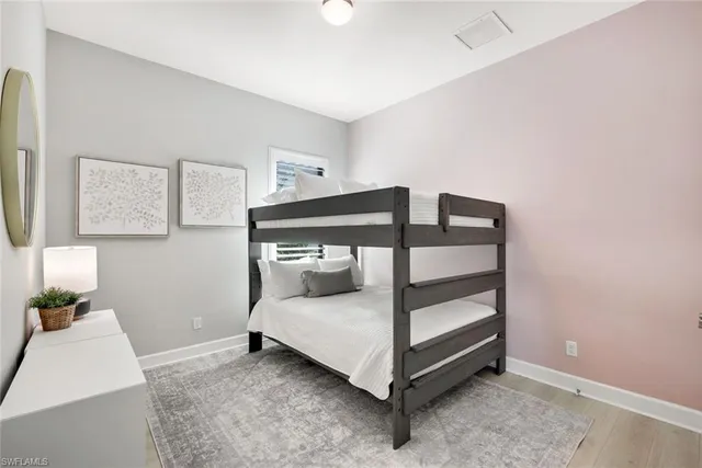 a bedroom with a bed and a night stand