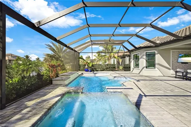 a view of a backyard with table and chairs under an umbrella