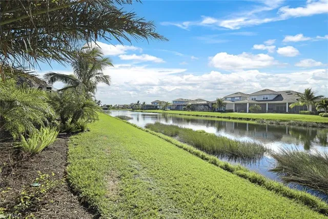 a view of a lake with houses in the back