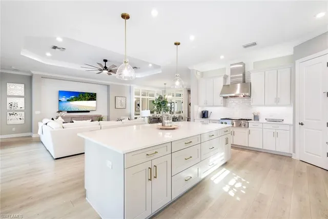 a kitchen with kitchen island white cabinets and sink