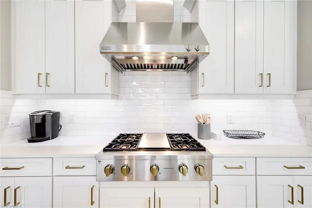 a stove top oven sitting inside of a kitchen