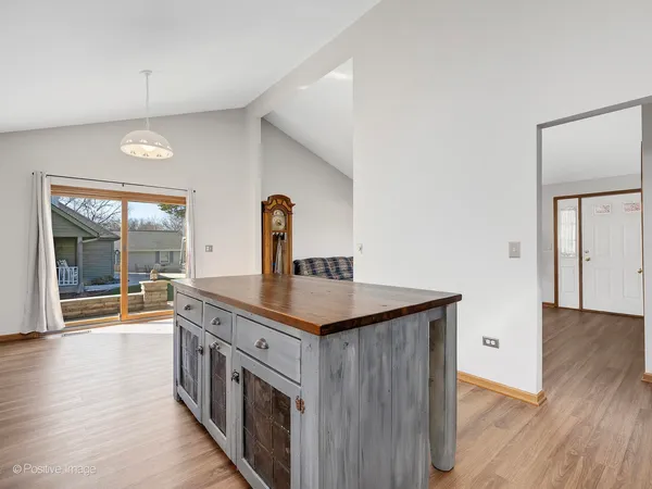a kitchen with a sink and wooden floor