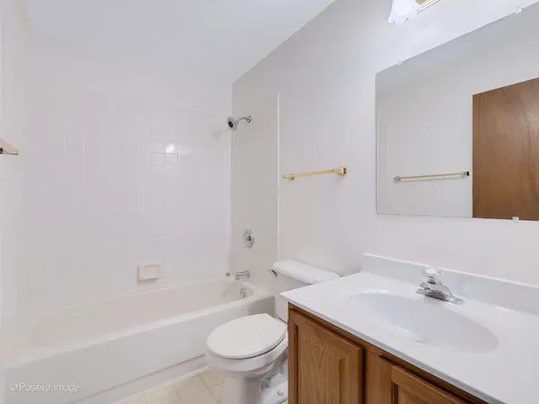 a bathroom with a sink toilet vanity and tub