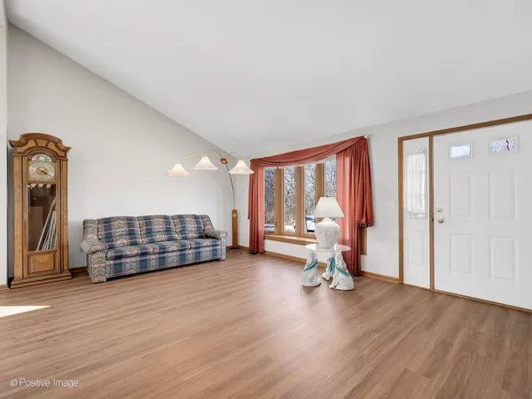 a view of a room with wooden floor and furniture