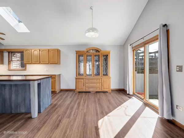 a view of a kitchen with wooden floor and a window
