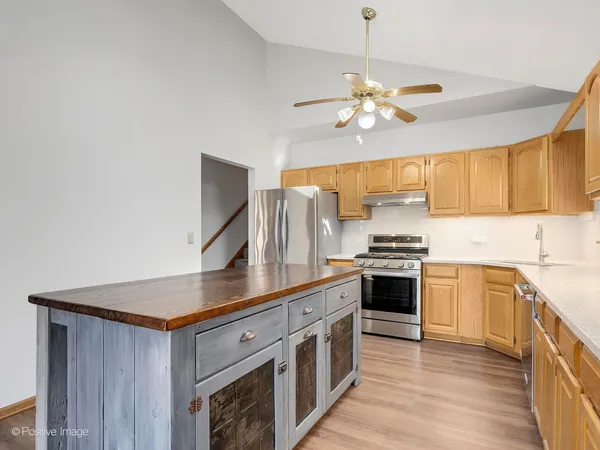a kitchen with stainless steel appliances granite countertop a stove and a sink