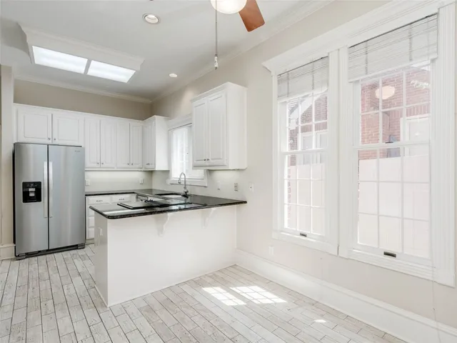 a kitchen with granite countertop a stove and a refrigerator