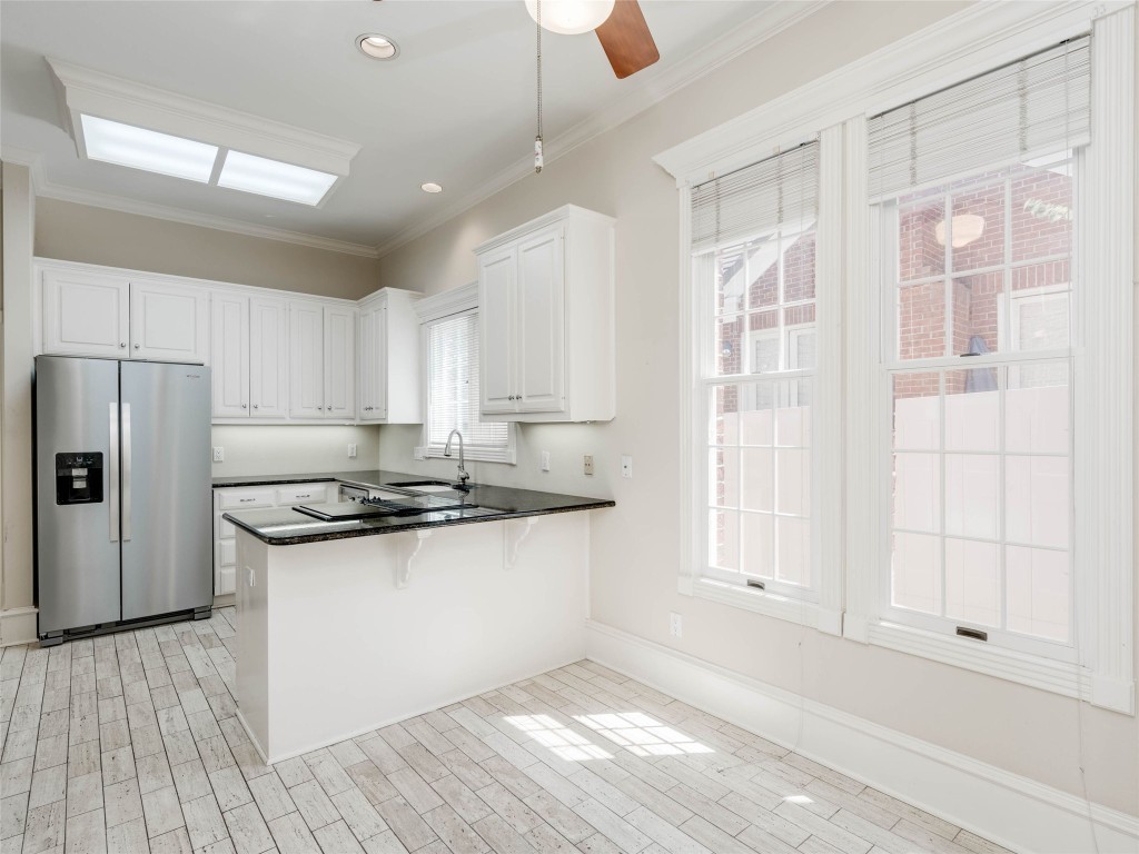 4010 Long Champ Drive, Unit 23 Austin, TX 78746 - Photo 11 of 38 a kitchen with granite countertop a stove and a refrigerator