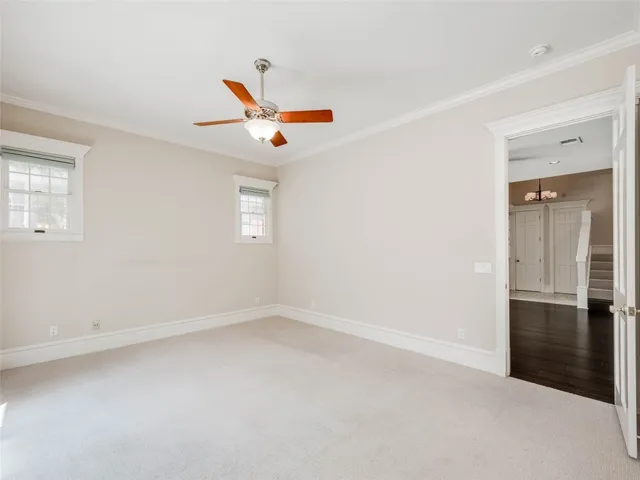 an empty room with closet and windows