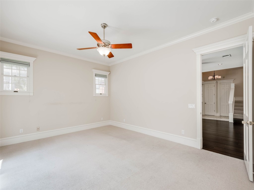 4010 Long Champ Drive, Unit 23 Austin, TX 78746 - Photo 17 of 38 an empty room with closet and windows