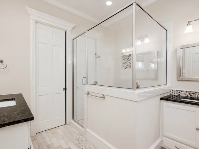 a bathroom with a shower and a mirror