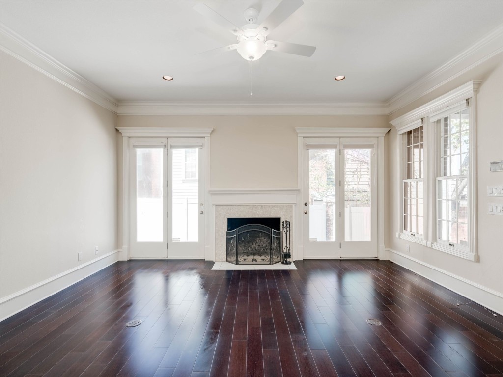 4010 Long Champ Drive, Unit 23 Austin, TX 78746 - Photo 2 of 38 a view of an empty room with wooden floor fireplace and a window
