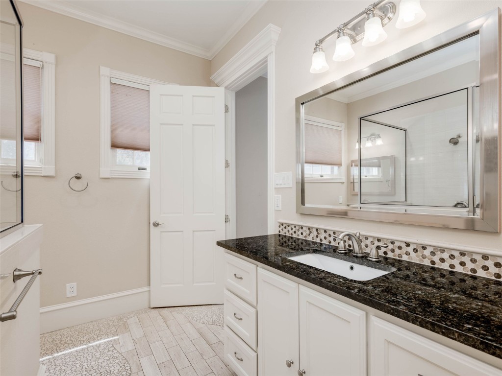 4010 Long Champ Drive, Unit 23 Austin, TX 78746 - Photo 21 of 38 a bathroom with a granite countertop sink and a mirror