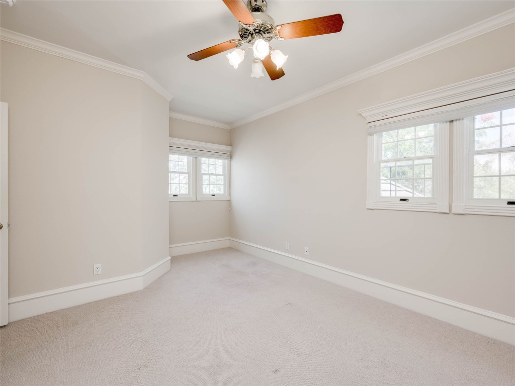 4010 Long Champ Drive, Unit 23 Austin, TX 78746 - Photo 22 of 38 an empty room with windows and fan