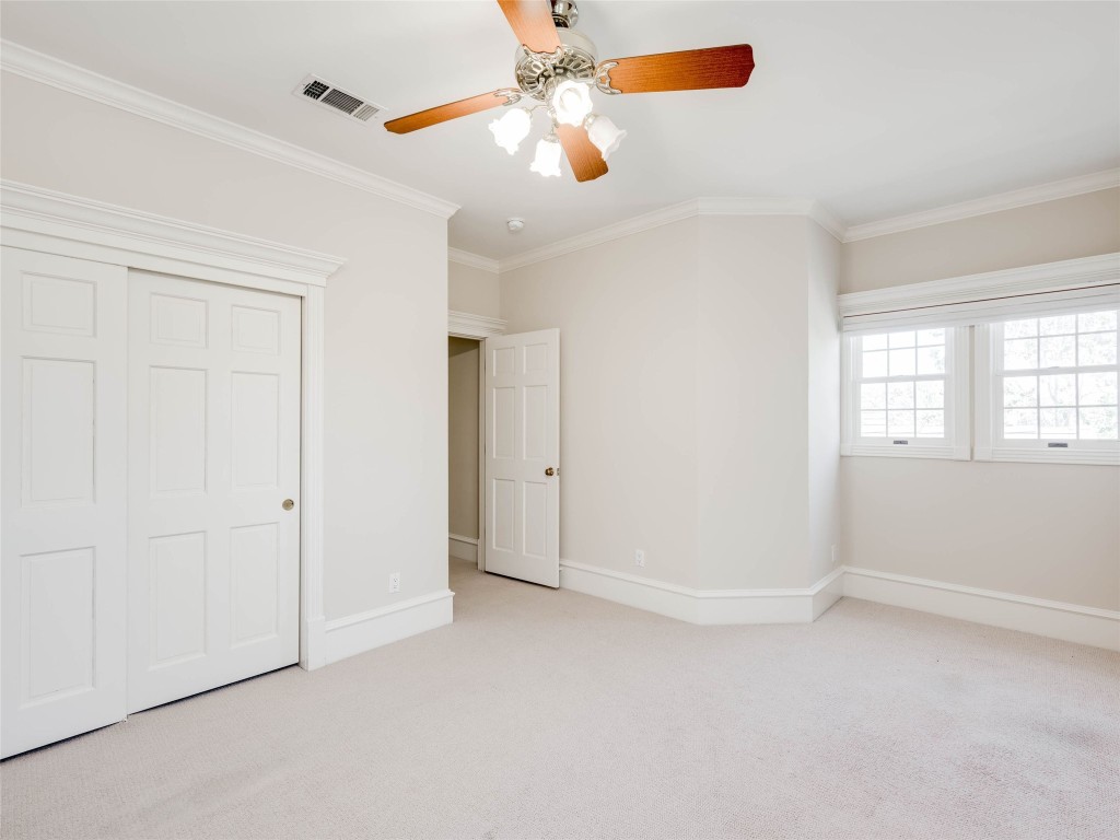 4010 Long Champ Drive, Unit 23 Austin, TX 78746 - Photo 23 of 38 an empty room with windows and fan