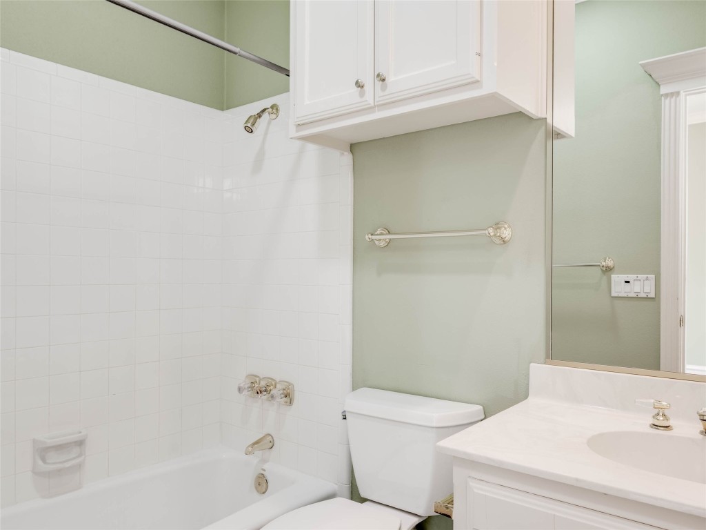 4010 Long Champ Drive, Unit 23 Austin, TX 78746 - Photo 27 of 38 a bathroom with a sink a toilet and shower