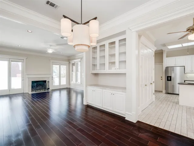 a view of empty room with wooden floor and fireplace