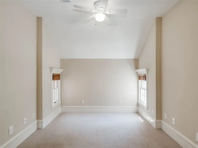 an empty room with a empty space and a ceiling fan