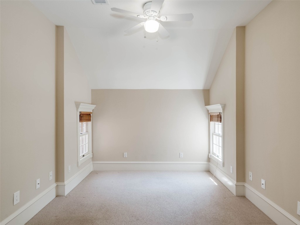 4010 Long Champ Drive, Unit 23 Austin, TX 78746 - Photo 33 of 38 an empty room with a empty space and a ceiling fan