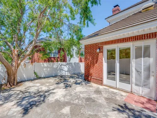 a view of a house with a yard and tree