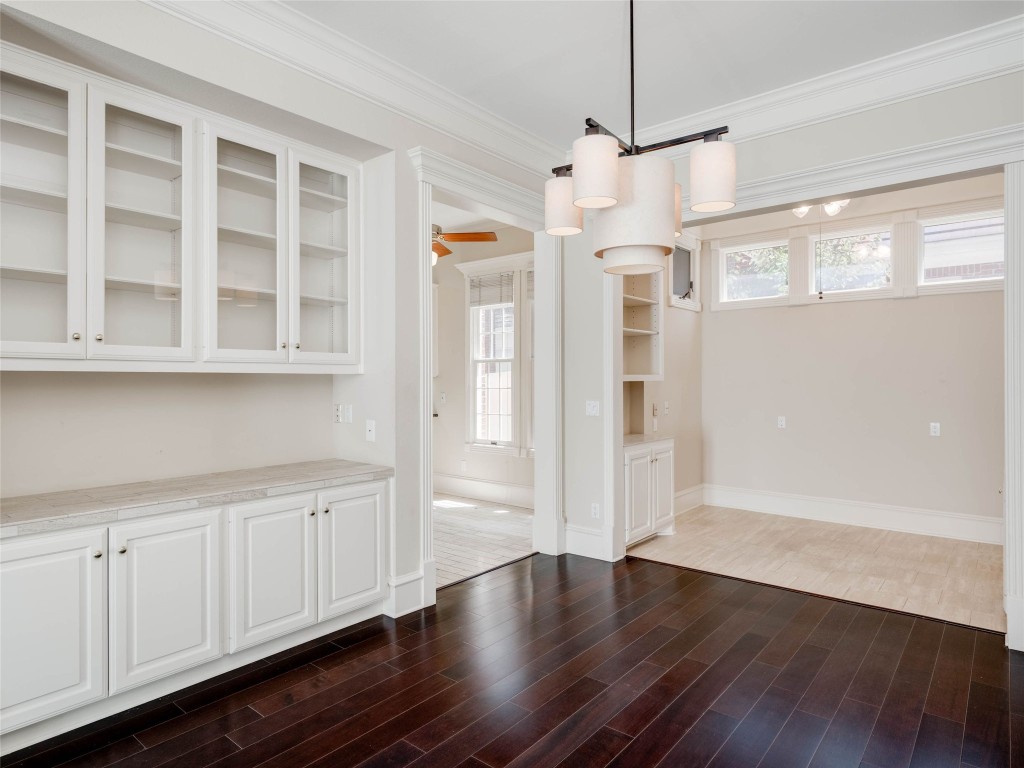 4010 Long Champ Drive, Unit 23 Austin, TX 78746 - Photo 5 of 38 a view of an empty room with wooden floor and a window