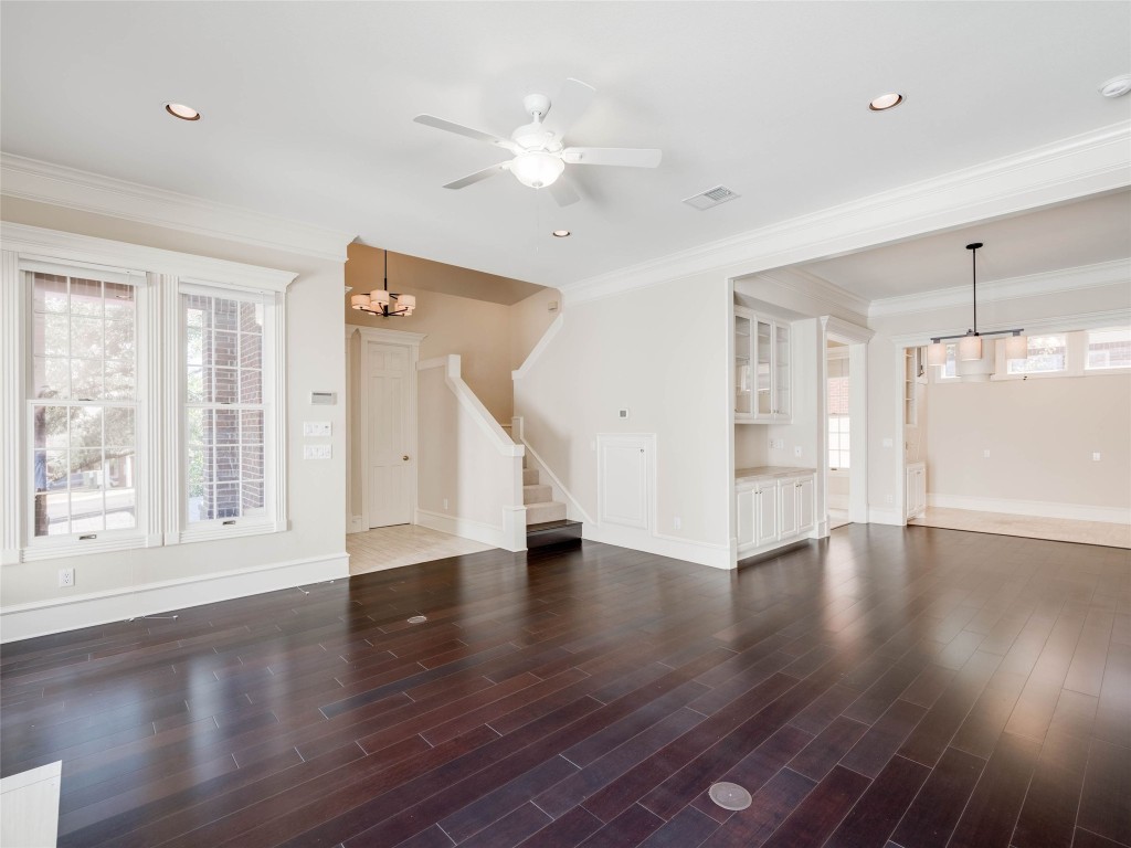 4010 Long Champ Drive, Unit 23 Austin, TX 78746 - Photo 10 of 38 a view of an empty room with wooden floor and a window