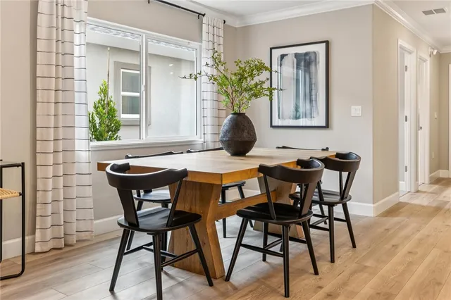 a dining room table with chair and window
