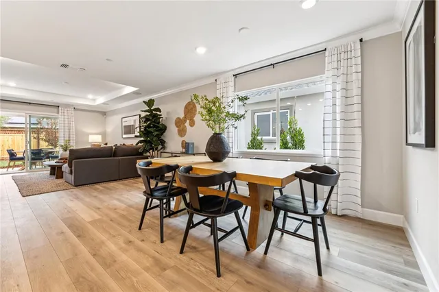 a dining room with furniture and wooden floor