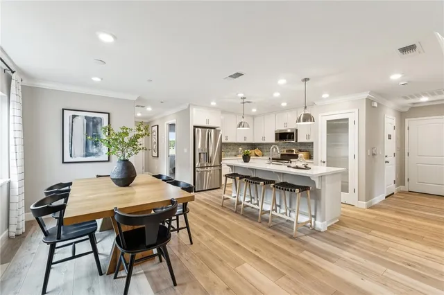 a kitchen with a table and chairs in it