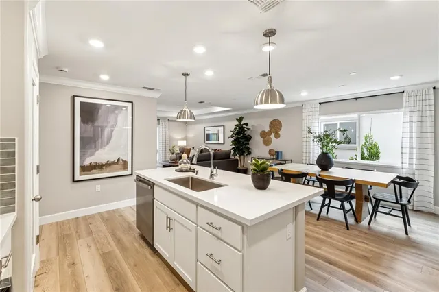 a open kitchen with a sink a counter top space appliances and a center island
