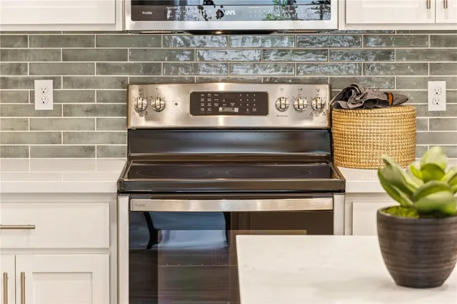 a stove top oven sitting inside of a kitchen