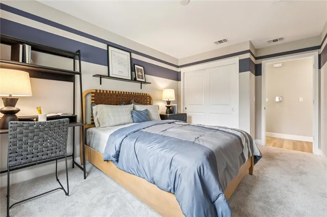 a bedroom with a bed and a dresser