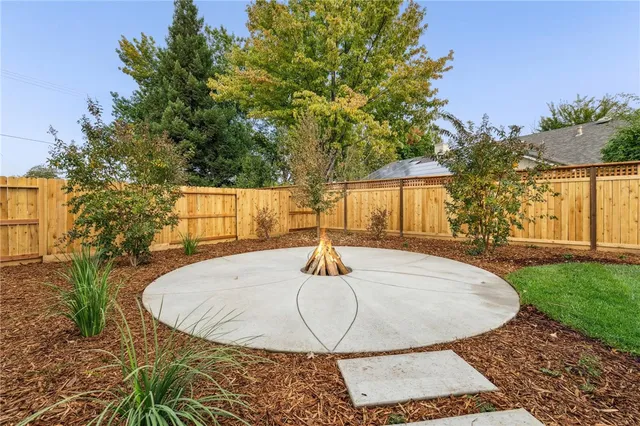 a backyard of a house with table and chairs