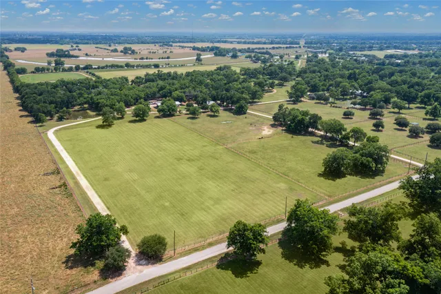 an aerial view of a house with a yard