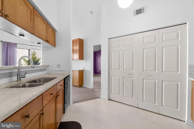 a kitchen with stainless steel appliances granite countertop white cabinets a stove top oven with wooden floor