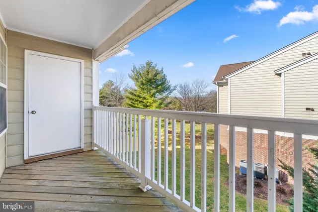 a view of a balcony with wooden floor