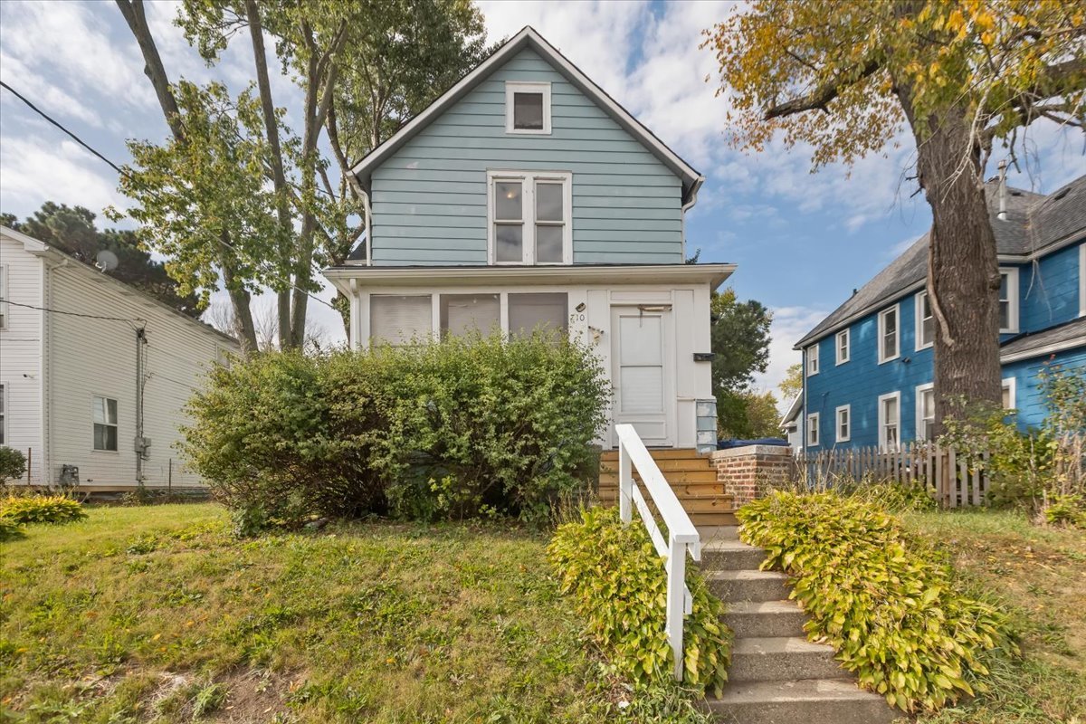 a front view of a house with garden