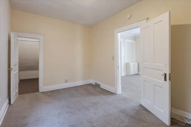 a view of an empty room and closet area