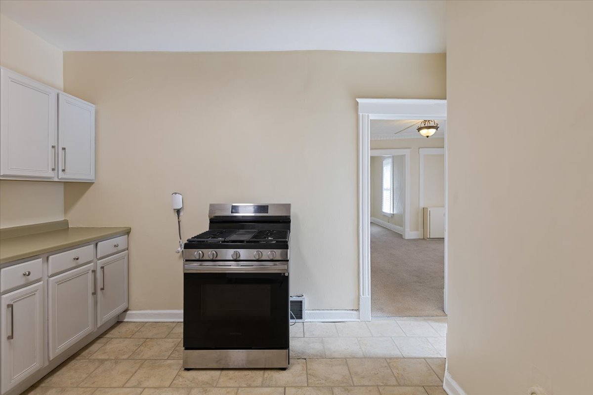 710 South Martin Luther King Junior Avenue Waukegan, IL 60085 - Photo 15 of 35 a kitchen with a stove and a cabinets