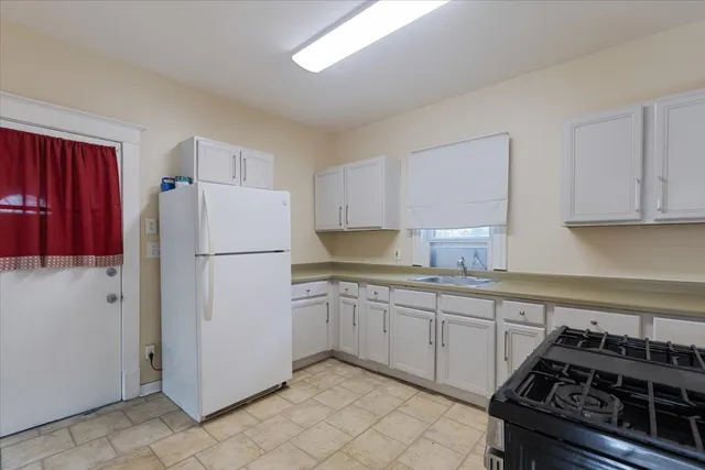 a kitchen with a stove a refrigerator and a sink