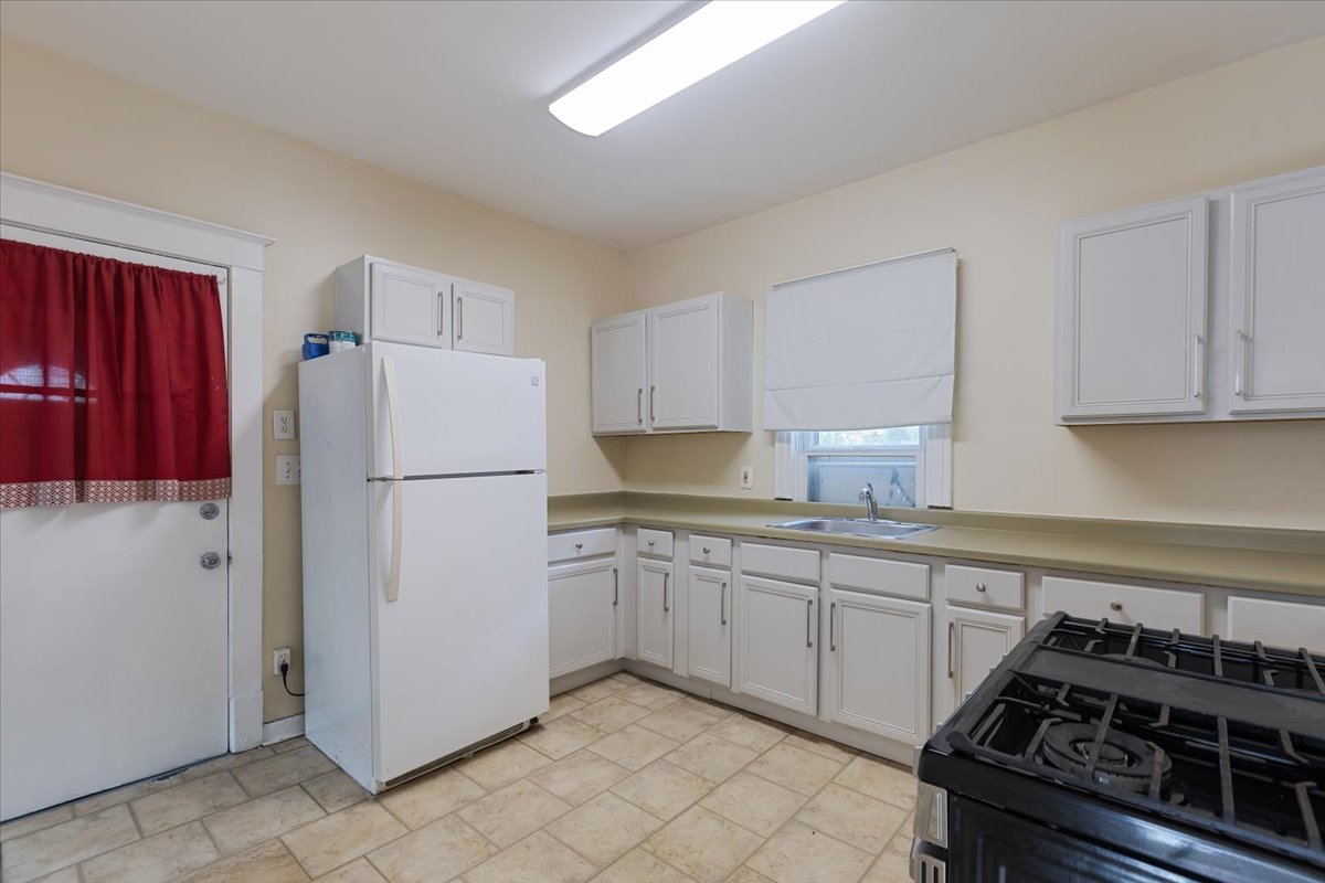 710 South Martin Luther King Junior Avenue Waukegan, IL 60085 - Photo 16 of 35 a kitchen with a stove a refrigerator and a sink